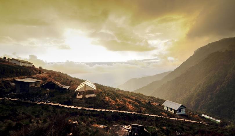 Breathtaking view of Zuluk village in East Sikkim on the Old Silk Route, with winding hairpin bends and stunning Kanchenjunga mountain scenery.